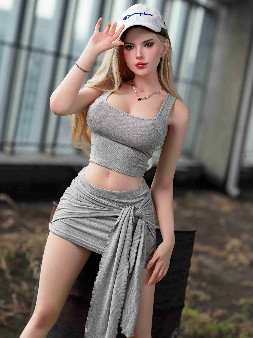 Alya-Rose adjusting the cap with one hand, the wrapped skirt open down her left leg
