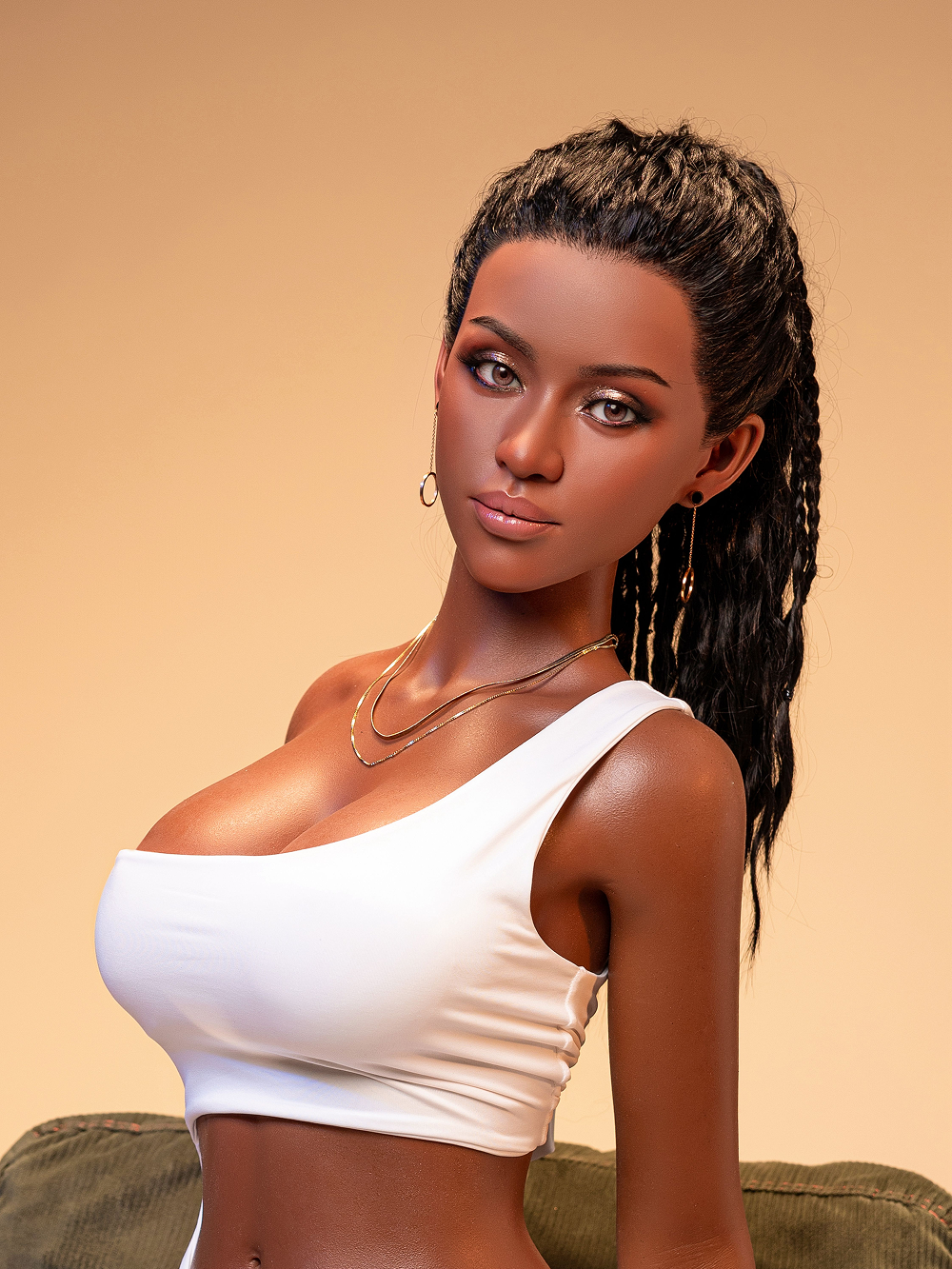 Anya from the waist up, the braided ponytail falling forward over a double gold chain