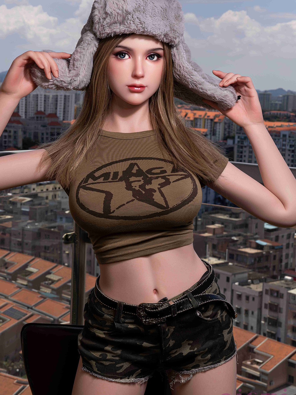 Camille with both hands on the ear flaps of the fur hat, tee cropped above the navel