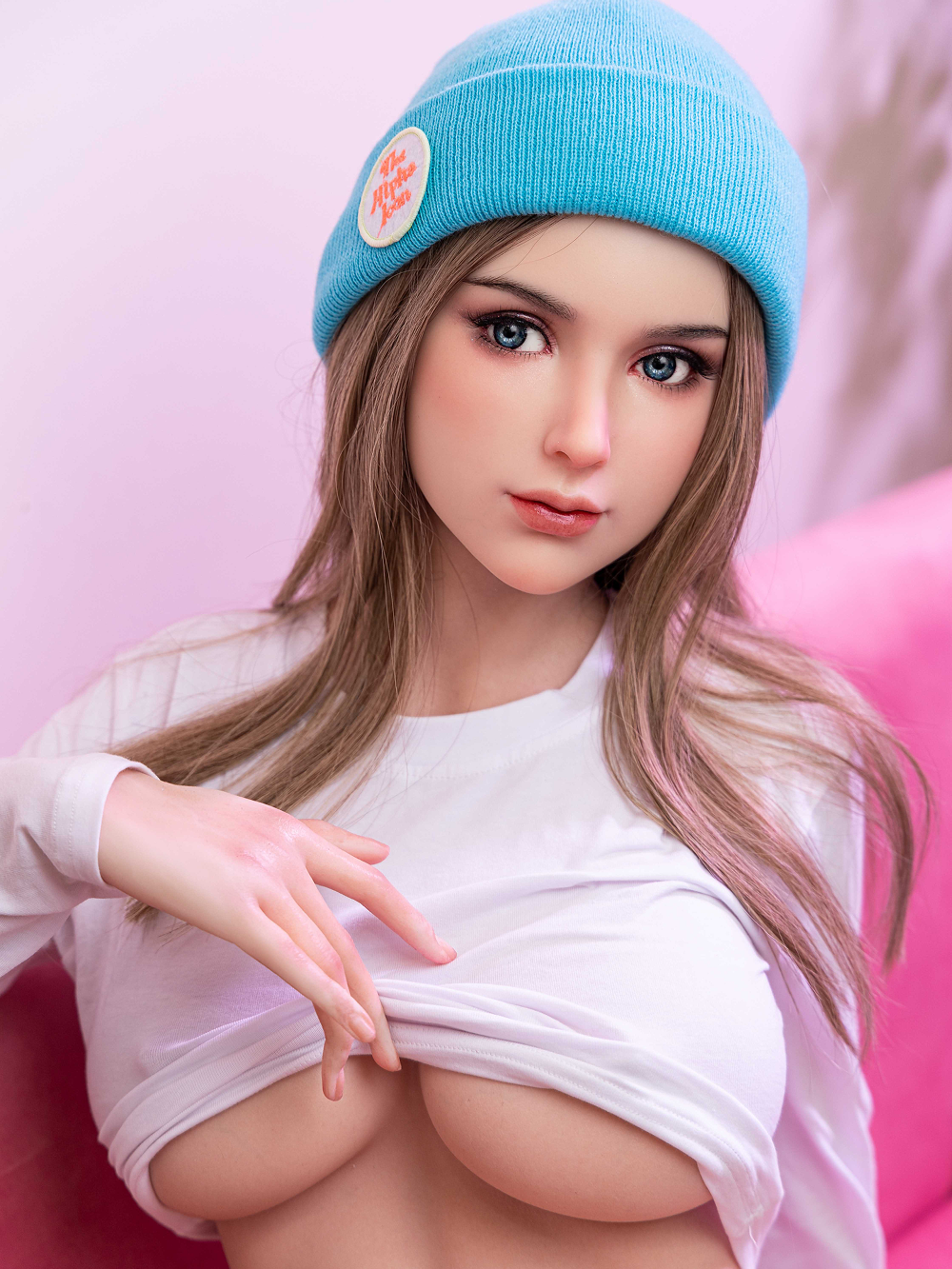 Chloe lifting the white top with both hands until the underside of a full C cup comes clear